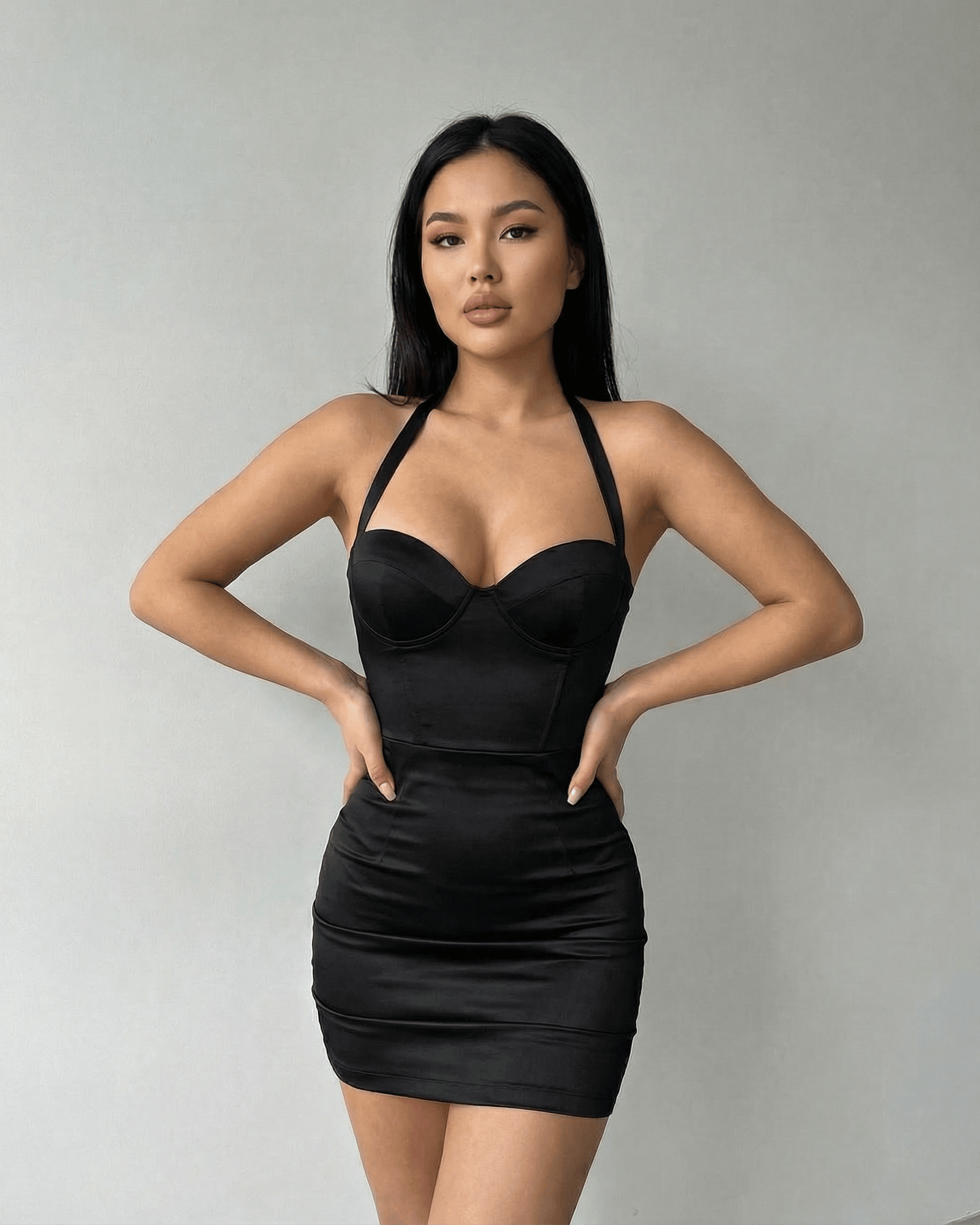 Model wearing Lauven Monaco Mini Dress – Black Satin Bodycon Halter Cocktail Mini Dress with sculpted cup detailing.