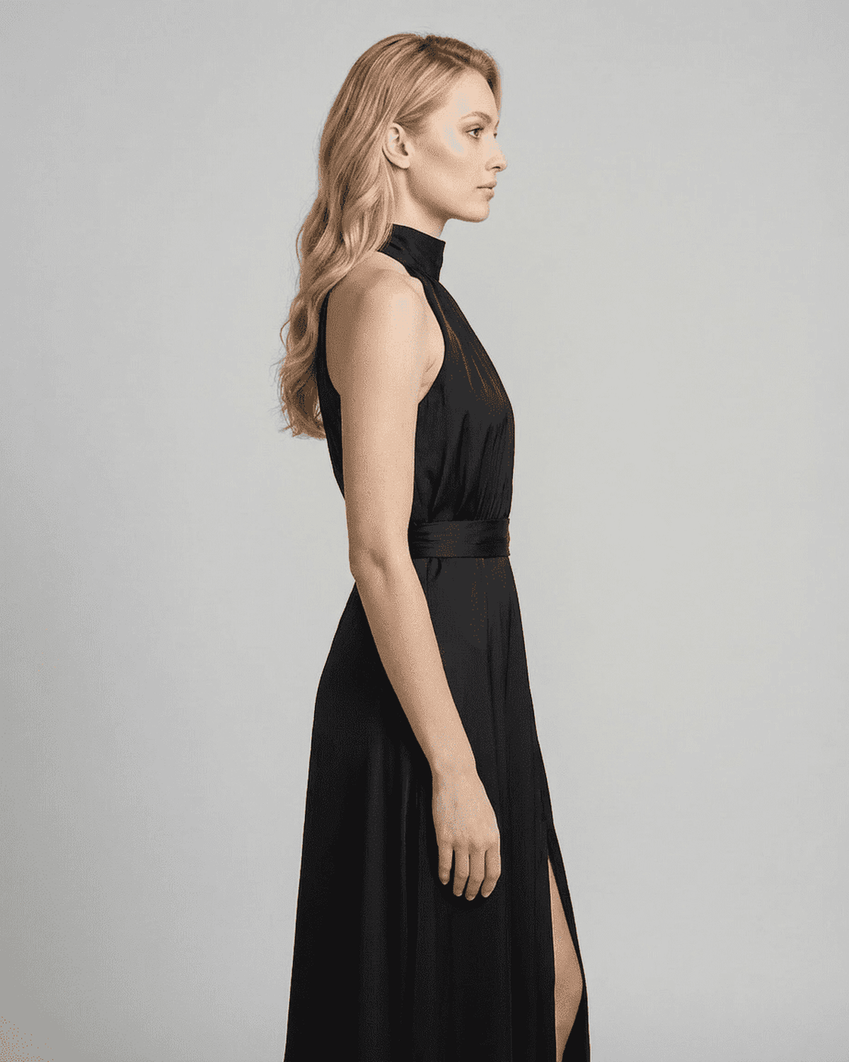Noctis Maxi Dress by SLIMONA, showcasing a sleeveless turtleneck style with a side slit in elegant black.