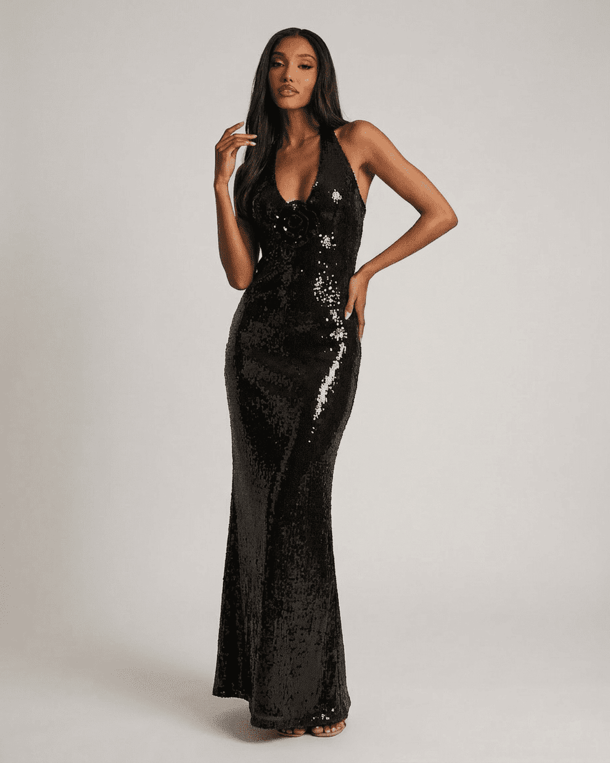 Noiré Maxi Dress by SLIMONA featuring a backless V-neck silhouette and floral sequin details, showcasing elegance.