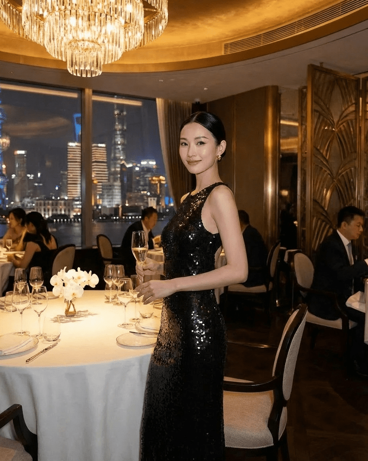 Elegant model in Noiré Maxi Dress at a fine dining table, showcasing sequins and floral detail by SLIMONA.