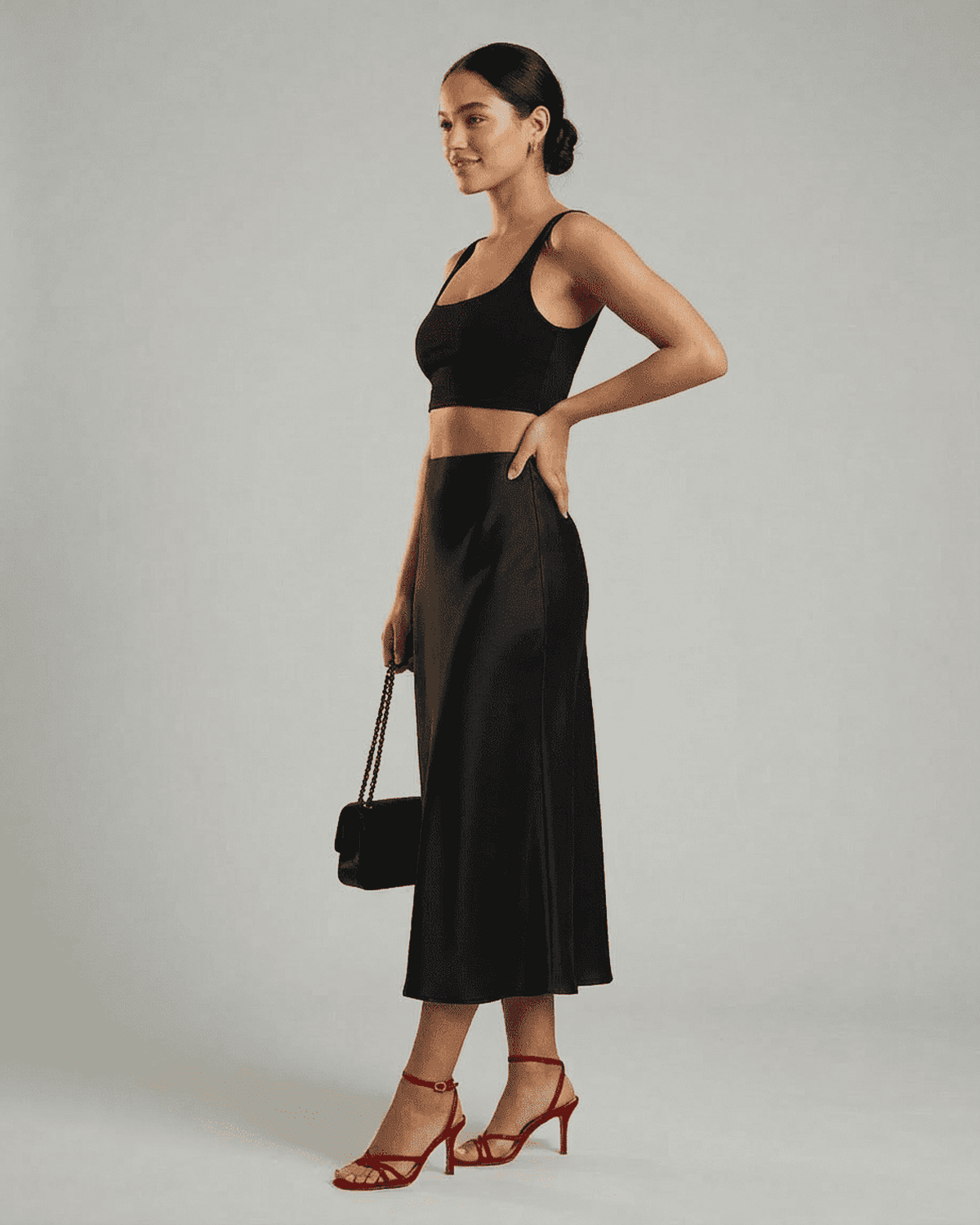 Noirelle Midi Skirt by SLIMONA – Elegant satin mermaid midi skirt in classic black, showcasing timeless style.