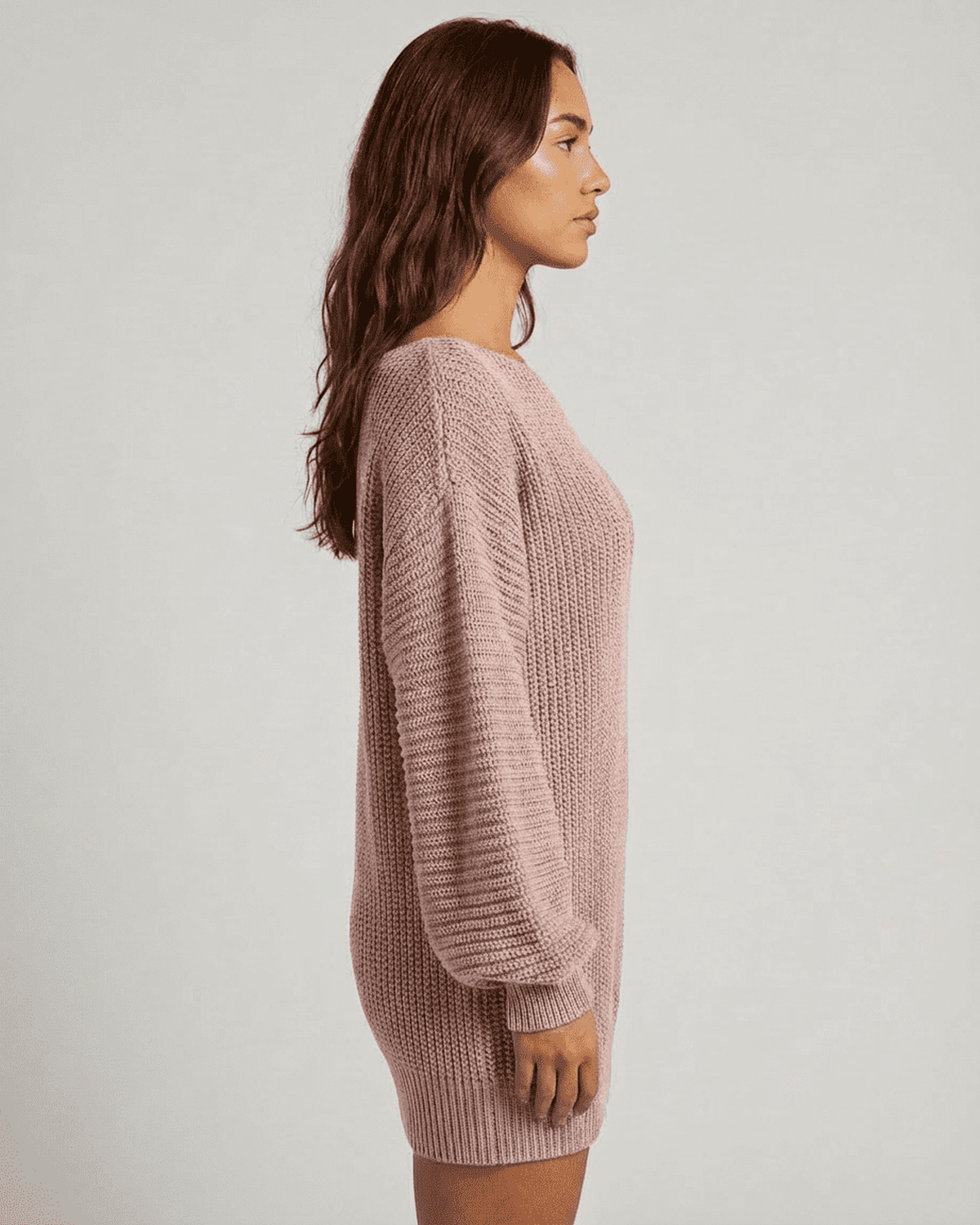 Side view of the SLIMONA Nova Mini Dress in soft pink ribbed knit, featuring off-the-shoulder lantern sleeves.