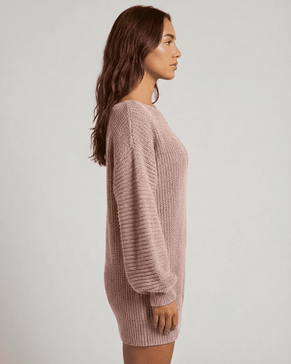 Side view of the SLIMONA Nova Mini Dress in soft pink ribbed knit, featuring off-the-shoulder lantern sleeves.