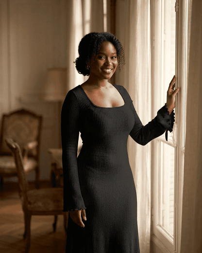 Woman wearing Nyx Maxi Dress by SLIMONA, featuring a ribbed knit, square neckline, and long sleeves.