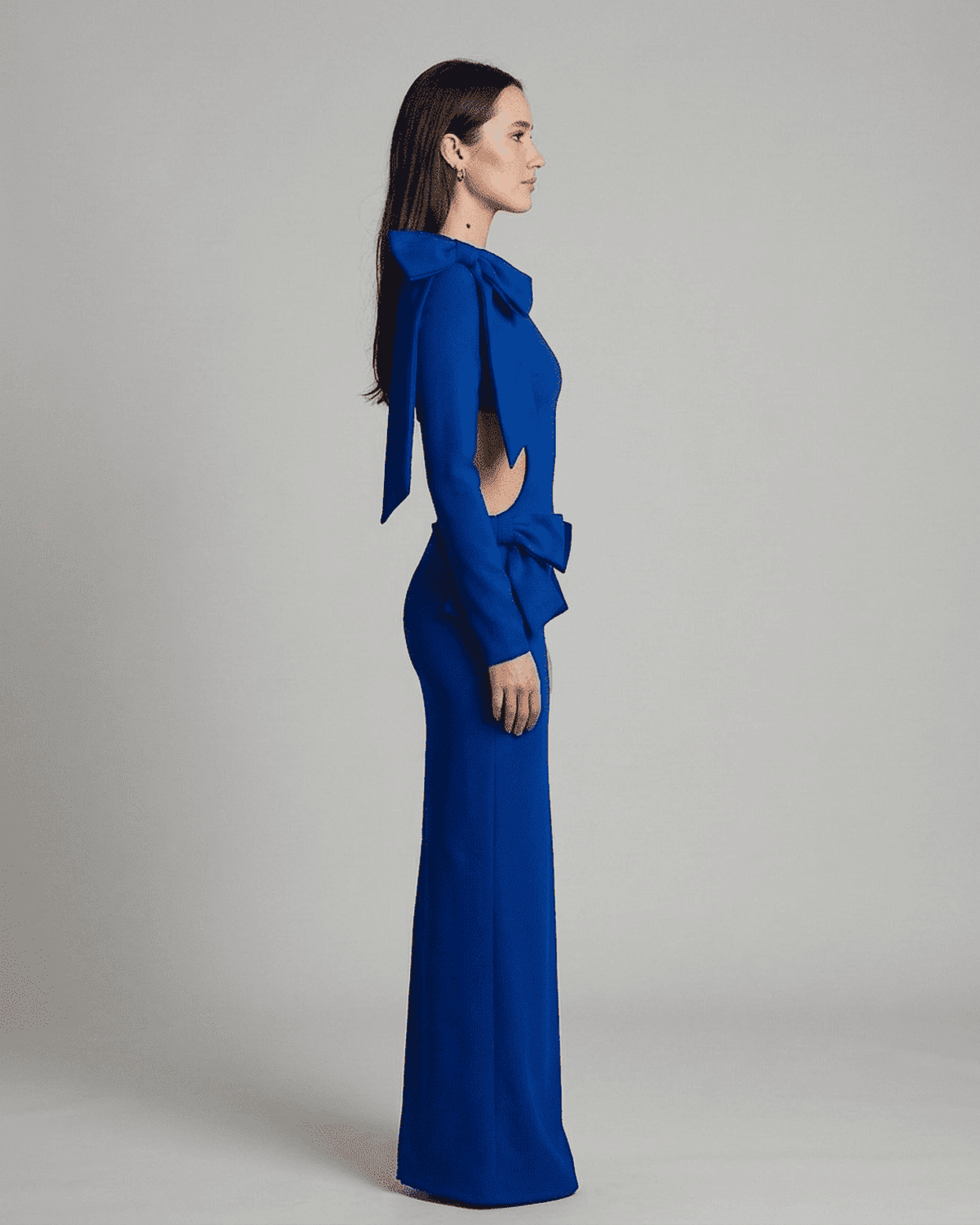 Orion Maxi Dress by SLIMONA, showcasing a side view of the long sleeve bodycon design with sculptural bows.