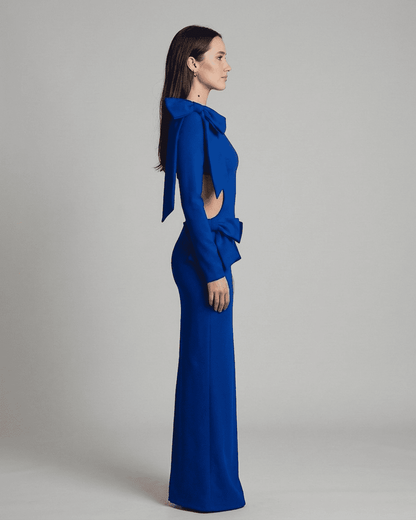 Orion Maxi Dress by SLIMONA, showcasing a side view of the long sleeve bodycon design with sculptural bows.
