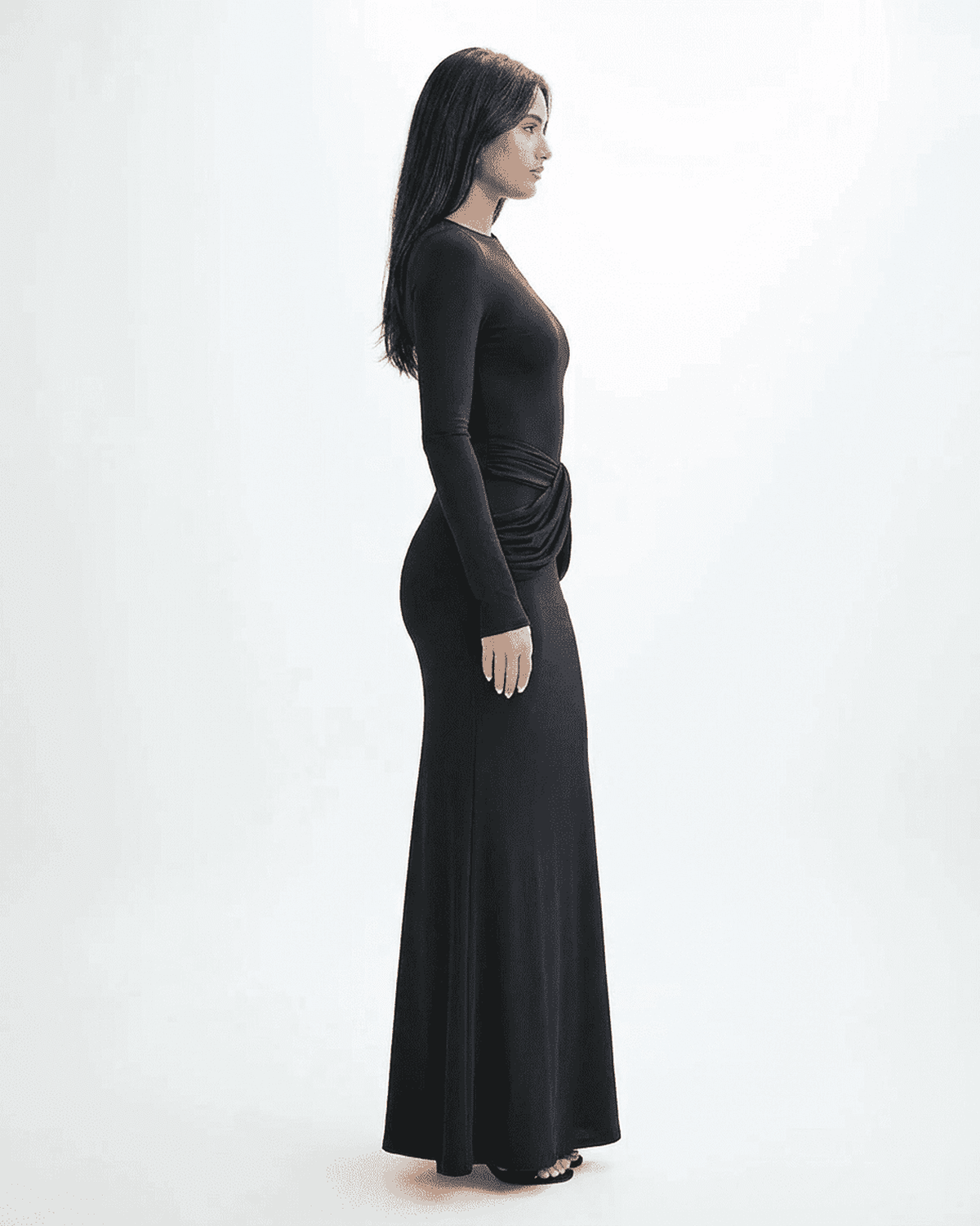 Orion Maxi Dress by SLIMONA, showcasing a side view of a long sleeve black dress with ruched detail.