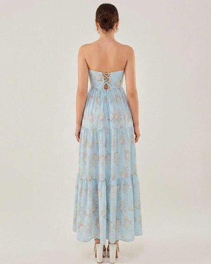 Back view of the Lauven Orion Midi Dress, showcasing its elegant strapless design and tiered skirt in light blue.