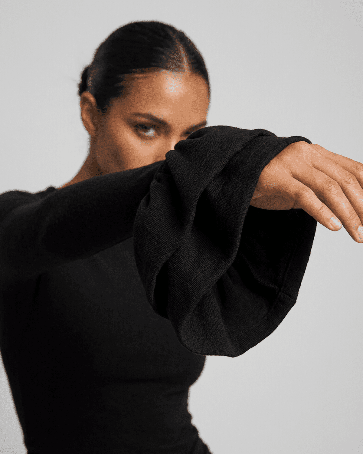 Orion Mini Dress by SLIMONA featuring elegant ruffled sleeves in black for a stylish look.