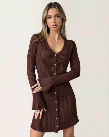 Model wearing the Orion Mini Dress by Lauven, a ribbed bodycon mini dress with flare sleeves and button details in deep chocolate brown.