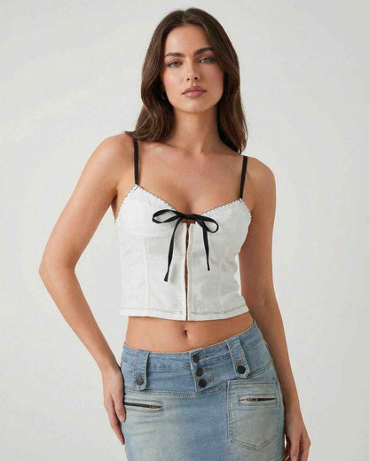 Arden Top by Lauven – White camisole with black bow detail, featuring delicate straps and a stylish silhouette.