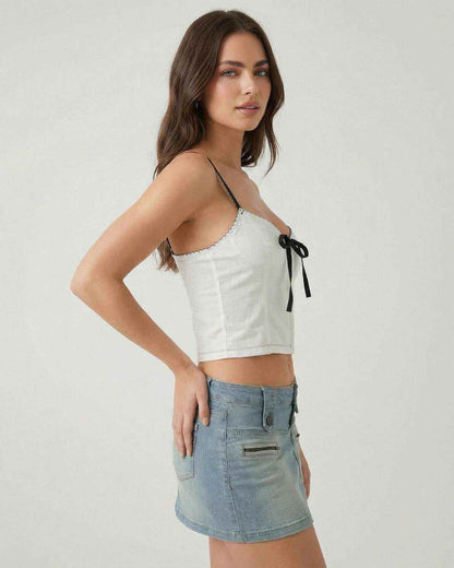 Arden Top by Lauven, white camisole with black bow detail, showcasing modern style and refined edge.