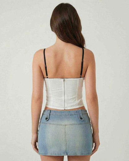 Back view of a woman wearing the Arden Top by Lauven, showcasing its white fabric and black straps.