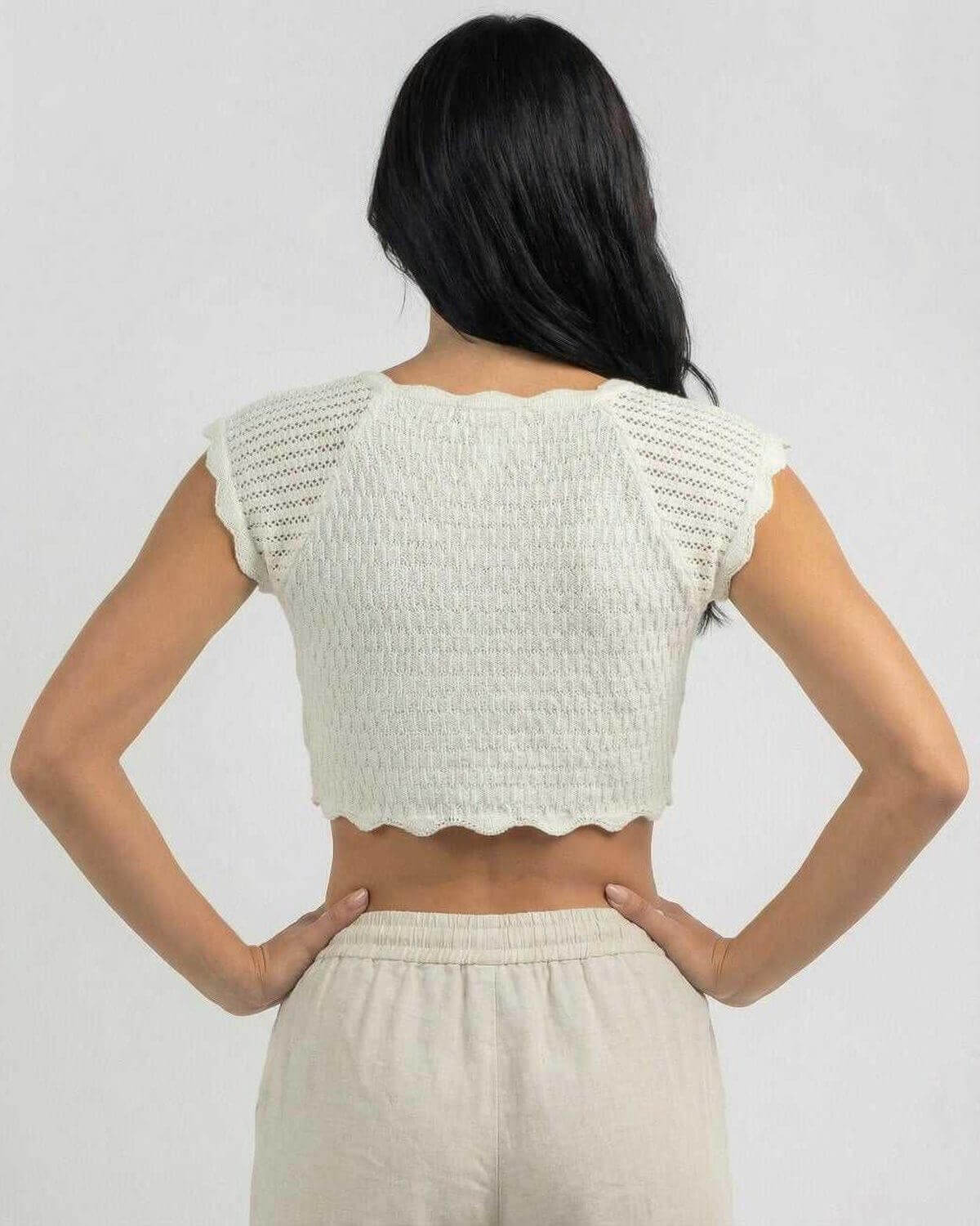 Back view of the Calista Top by Lauven, showcasing its unique lettuce trim design and comfortable fit.