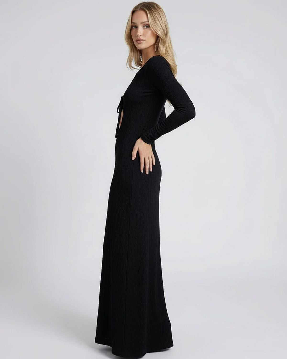 Model wearing the Elysian Maxi Dress by Lauven, featuring a sleek black design with hollow-out details.