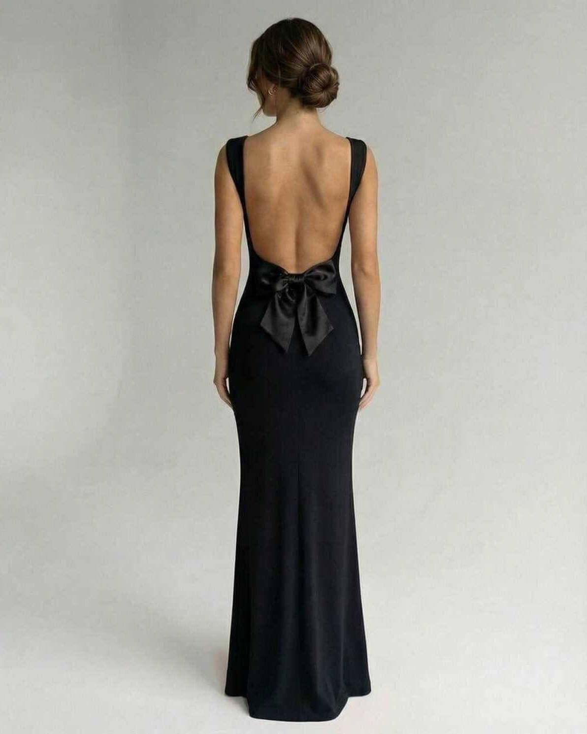 Obsidian Maxi Dress by Lauven, featuring a sleek back design with a bow detail, perfect for elegant occasions.