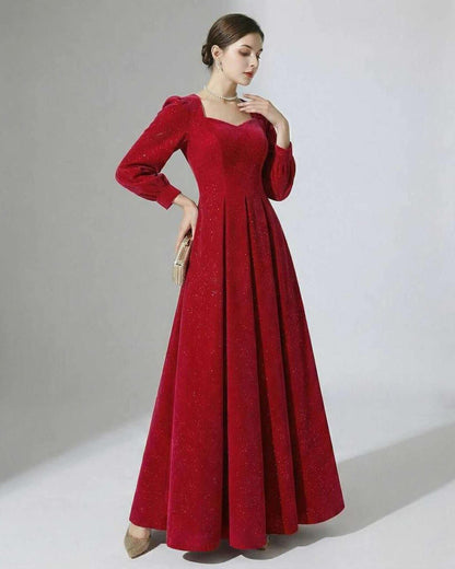Celeste Maxi Dress by Lauven, elegant red A-line velvet gown with puff sleeves and subtle glitter accents.