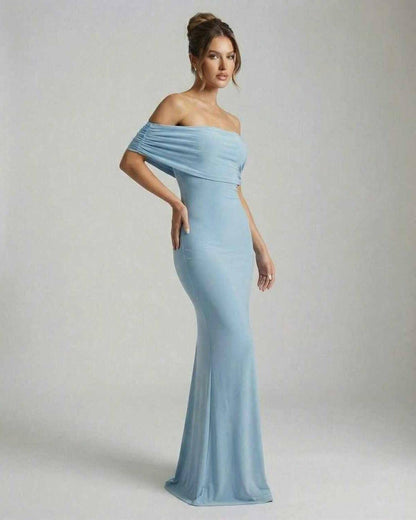 Lauven Luna Maxi Dress in sleek off-shoulder light blue silhouette, showcasing refined ruched details and elegant floor-length design.