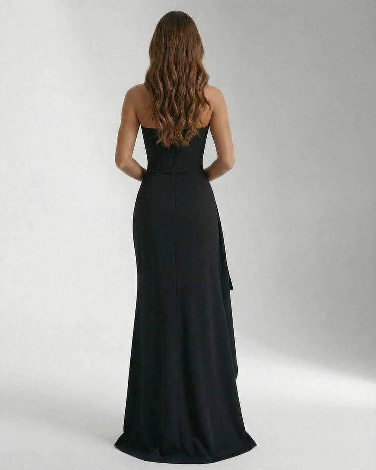 Back view of the Celeste Maxi Dress by Lauven, featuring a sleek and elegant strapless design and thigh-high slit.