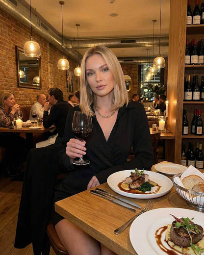 Orion Mini Dress by Lauven, elegant black shirt dress with long sleeves, worn in an upscale dining setting.