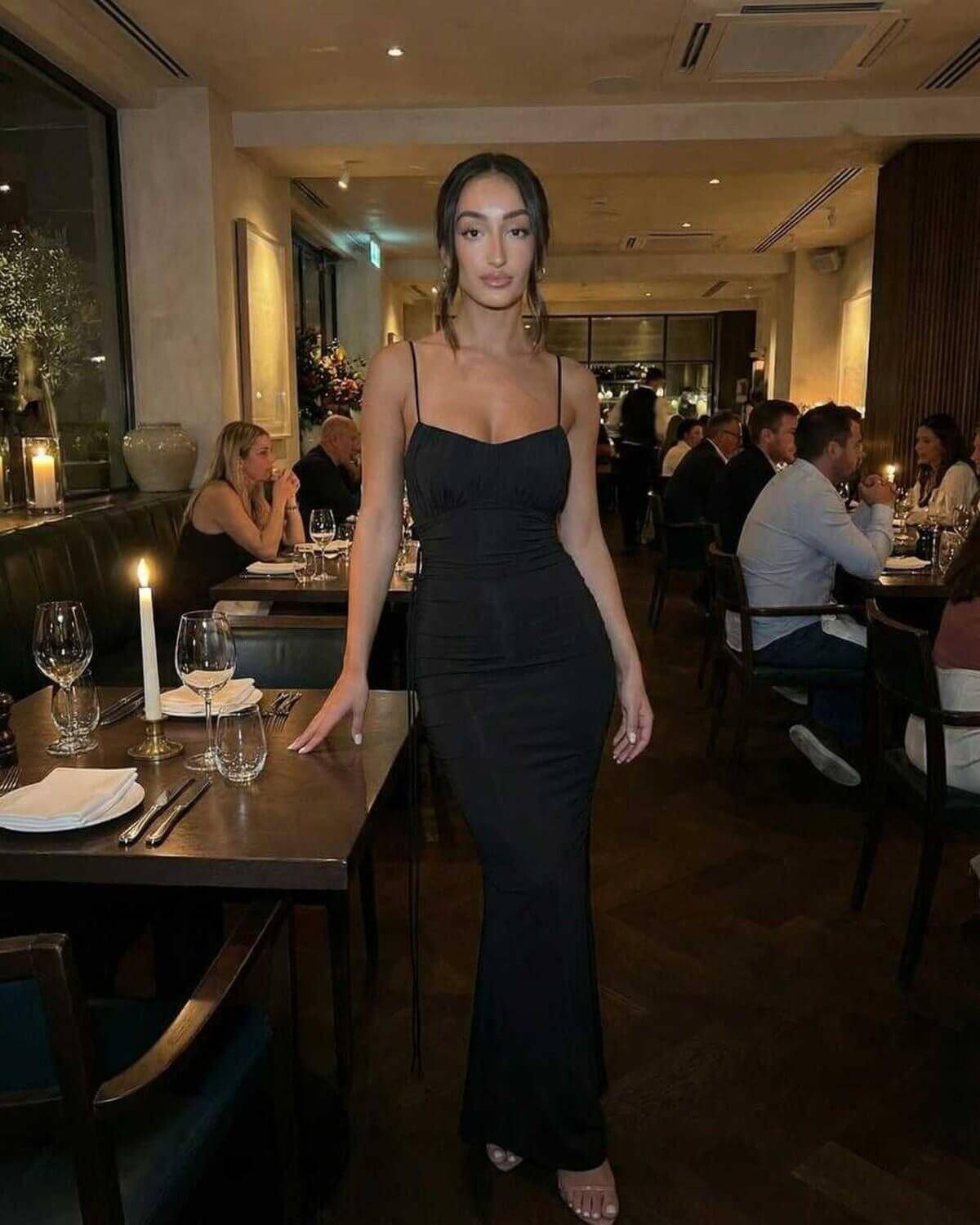 Isla Maxi Dress by Lauven - Black sleeveless spaghetti strap sheath dress, elegant fit in a restaurant setting.