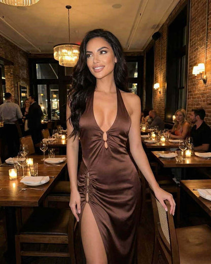 Model wearing Sienna Maxi Dress by Lauven, showcasing sleek satin fabric and elegant details in a stylish restaurant setting.