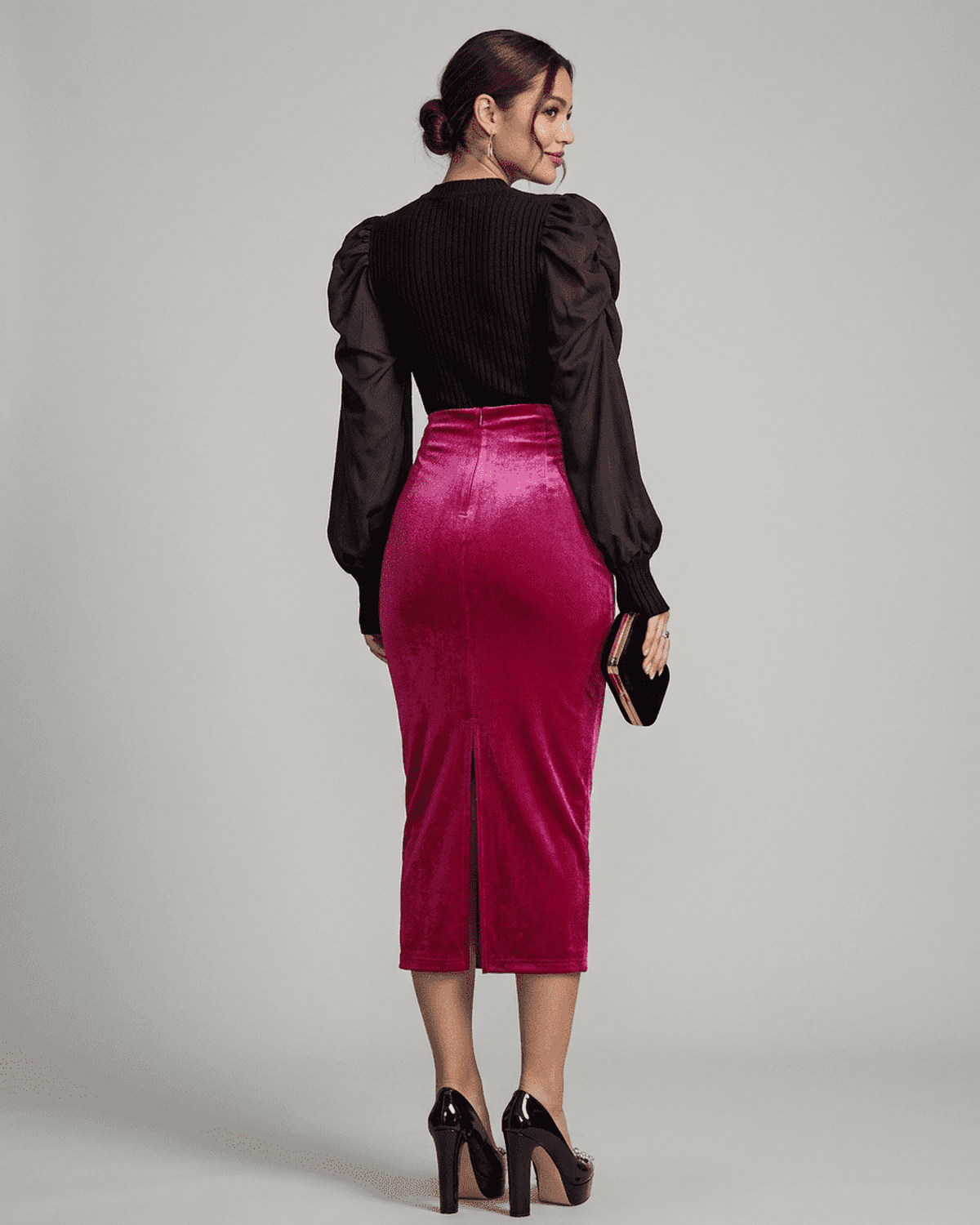 Back view of Rosalia Midi Skirt by SLIMONA, featuring a high-waisted velvet pencil design with an elegant back slit.