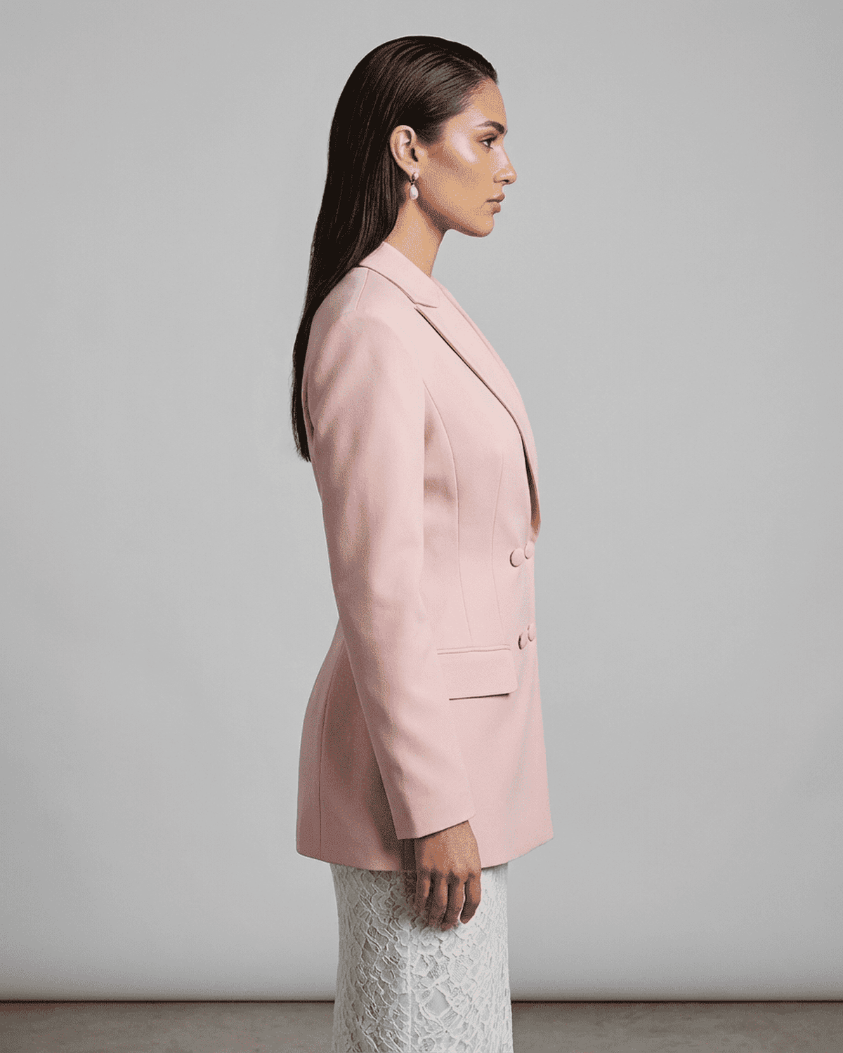 Rosalie Blazer by SLIMONA in pink, showcasing a tailored silhouette and double-breasted design from the side view.