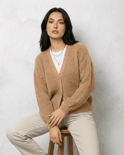 Saffron Cardigan by SLIMONA – Elegant beige knitwear with relaxed V-neck silhouette and long sleeves.