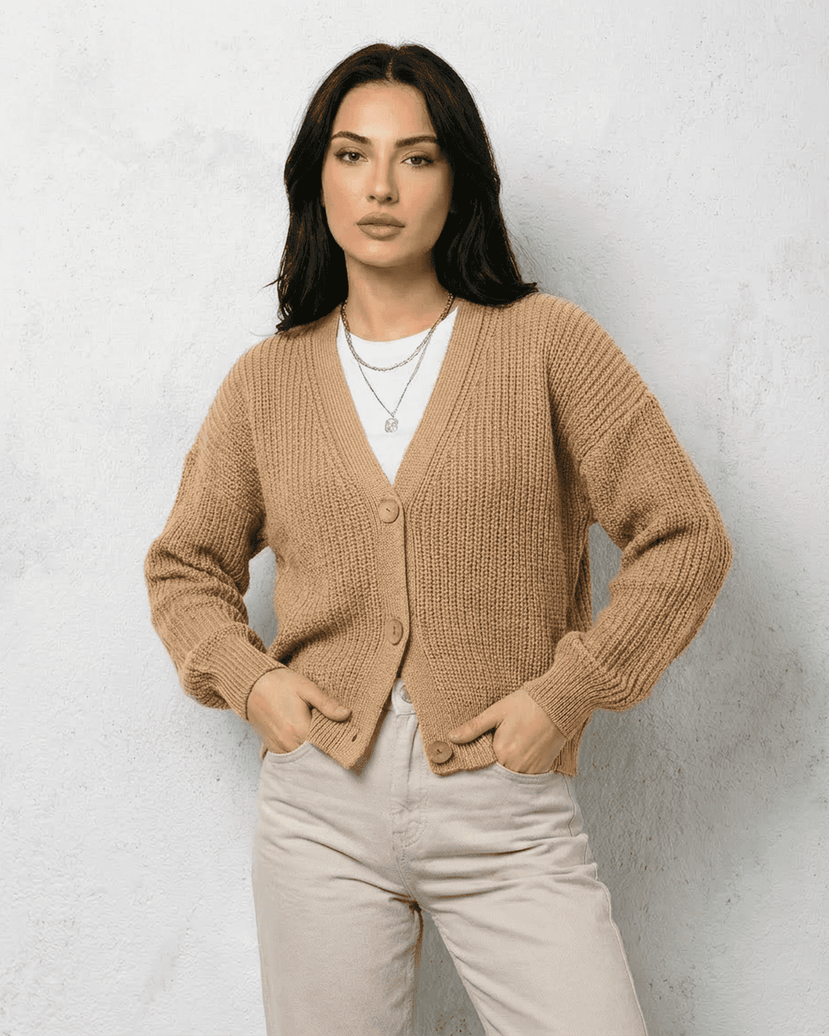 Saffron Cardigan by SLIMONA - Elegant beige knitwear with relaxed V-neck silhouette and button closure.