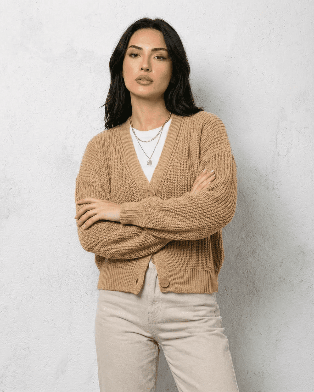 Saffron Cardigan by SLIMONA, beige knitwear featuring a relaxed V-neck and long sleeves for cozy layering.