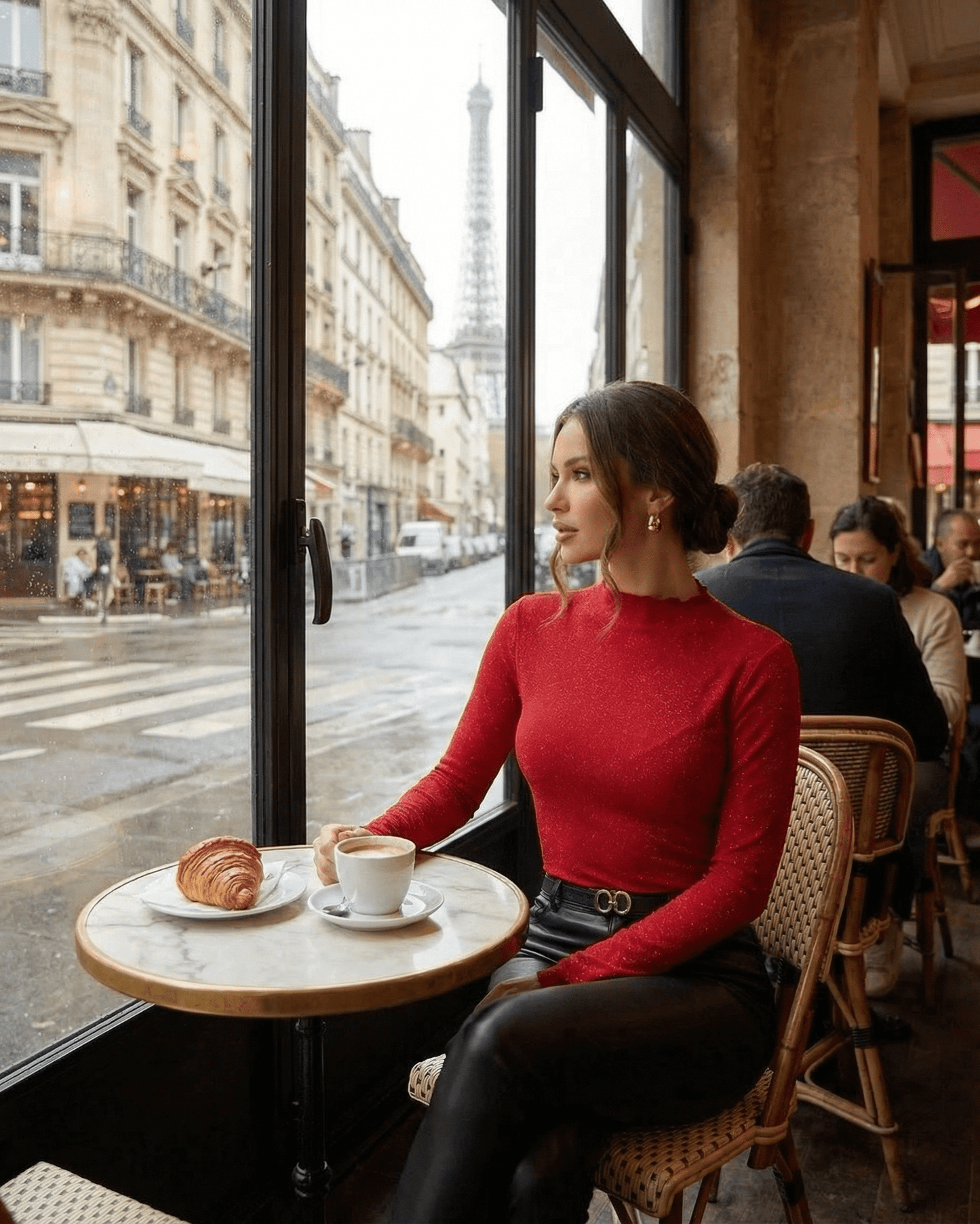 Scarlet Blouse worn by a woman at a café with a view of the Eiffel Tower, showcasing its elegant style.