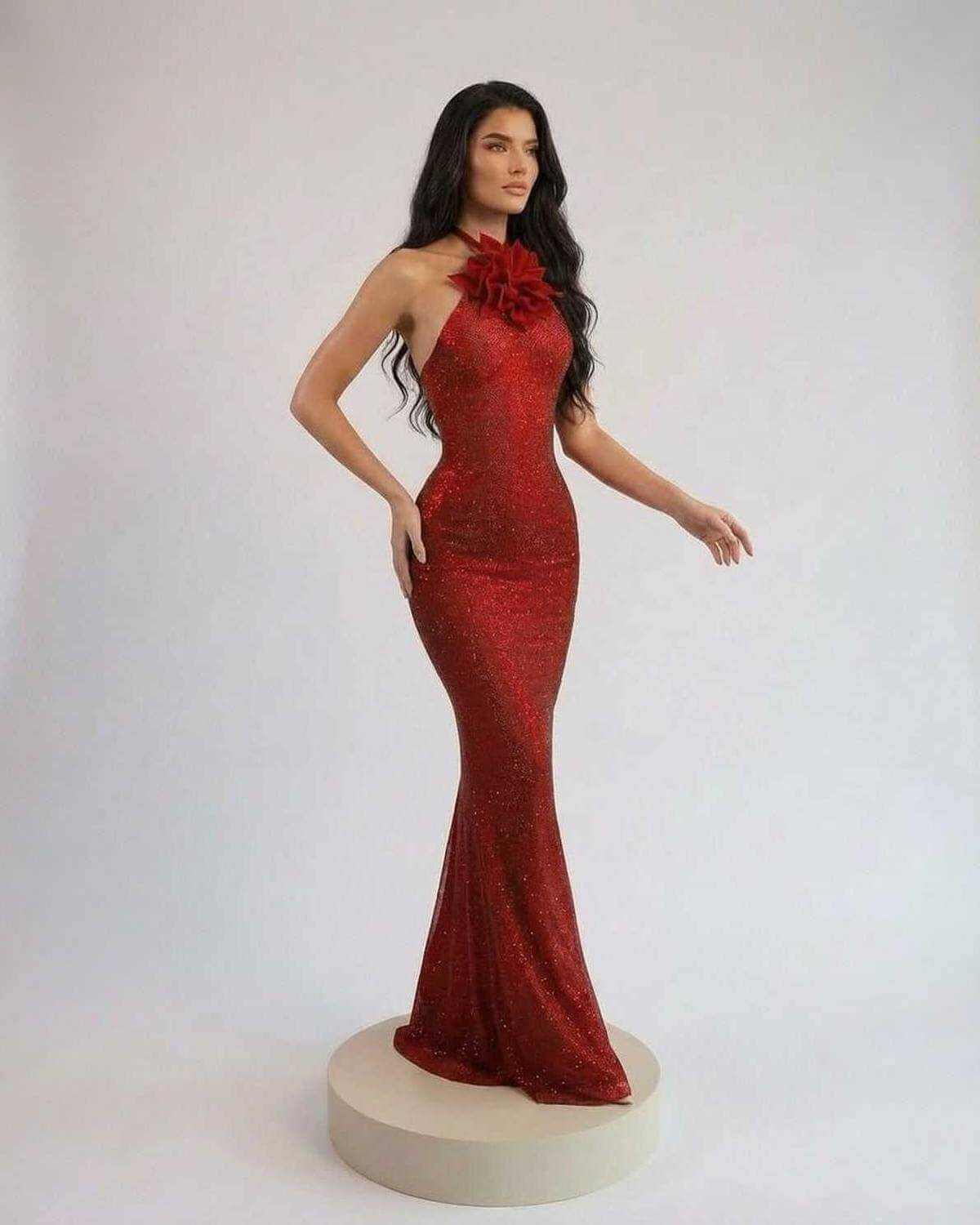 Scarlet Maxi Dress by SLIMONA featuring halter neck, floral detail, and floor-length silhouette in rich red tone.