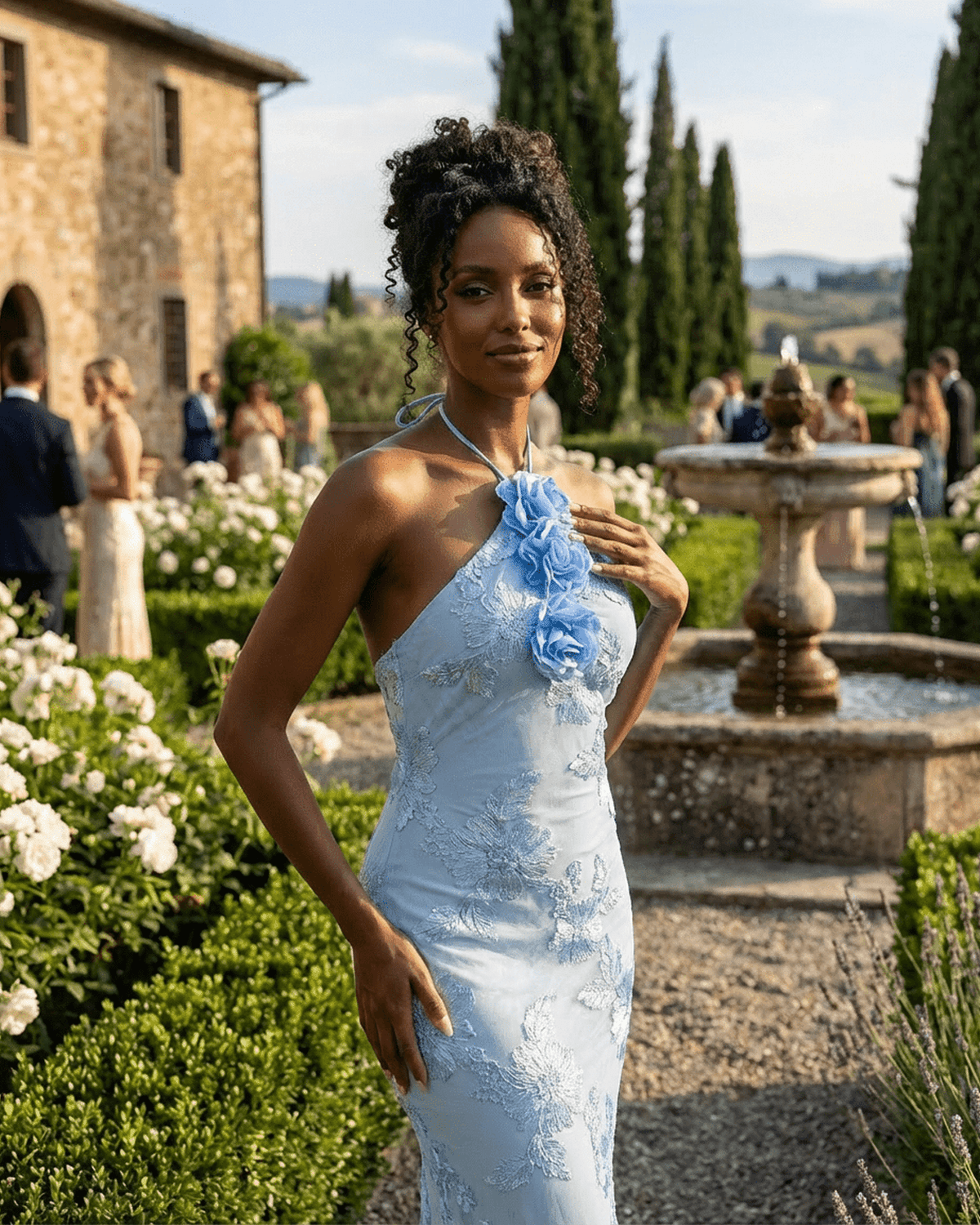 Serena Maxi Dress from SLIMONA, showcasing a halter neck design with floral details in an elegant light blue setting.