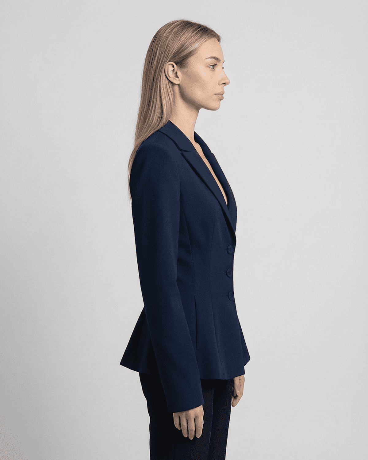 Aurora Blazer by SLIMONA showcasing a fitted waist and V-neckline in a sleek navy design.
