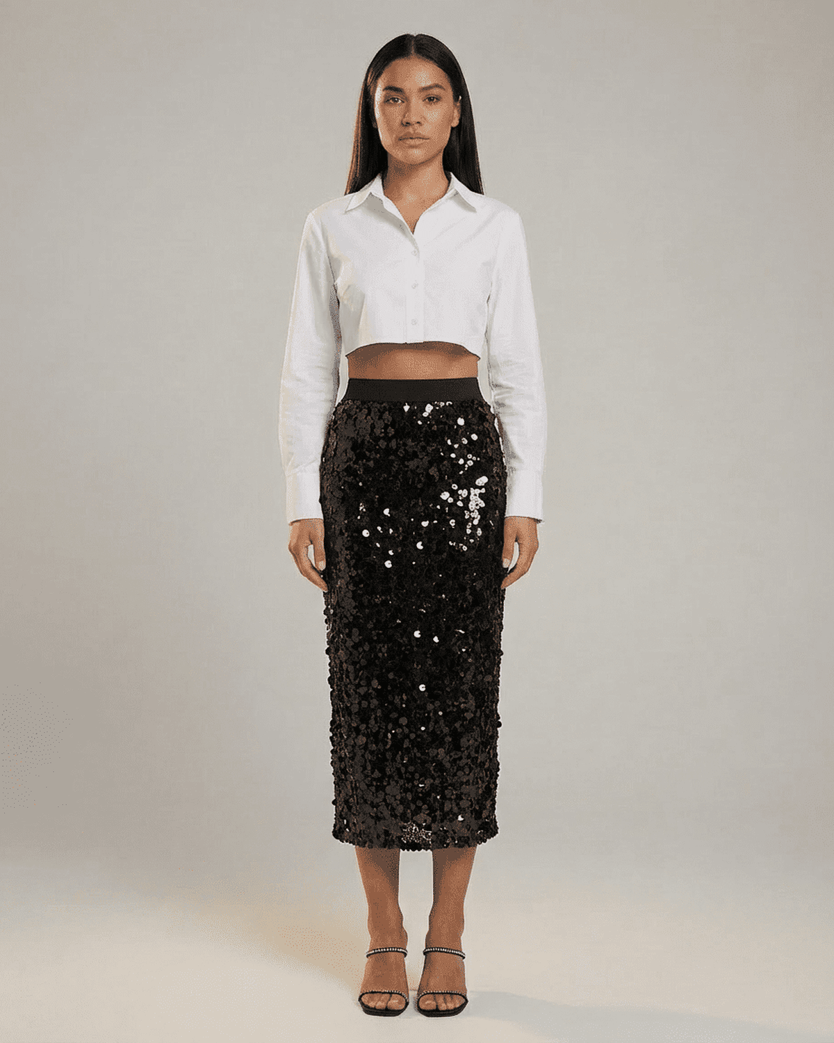 Model wearing SLIMONA Noctura Midi Skirt, a black sequin bodycon midi skirt with high waist.