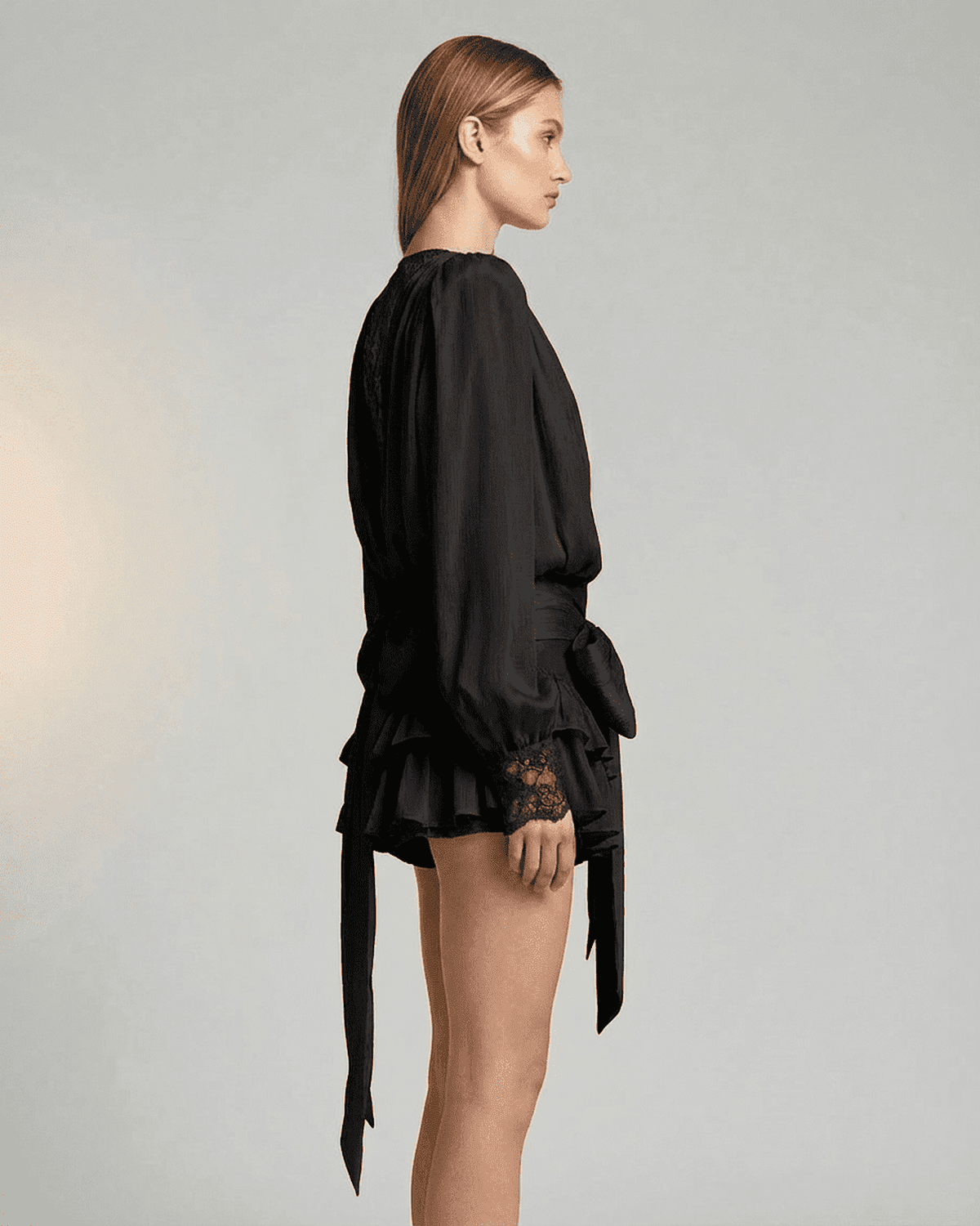 Noir Mini Dress by SLIMONA, showcasing lace detail and a tiered silhouette in elegant black.