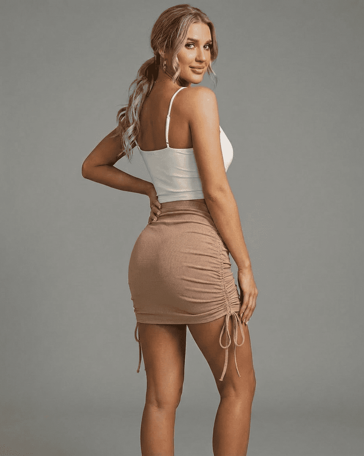 Model showcasing the SLIMONA Sand Mini Skirt with adjustable drawstrings and rib-knit texture.