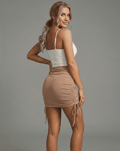 Model showcasing the SLIMONA Sand Mini Skirt with adjustable drawstrings and rib-knit texture.