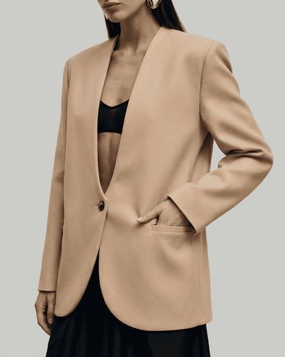 Savona Blazer by SLIMONA, women's fitted beige blazer with deep V-neckline and tailored silhouette.