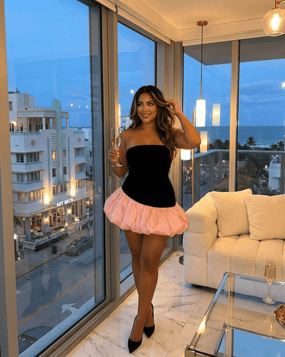 Selina Mini Dress by SLIMONA features a black strapless top and a pink puff skirt, perfect for a chic evening look.