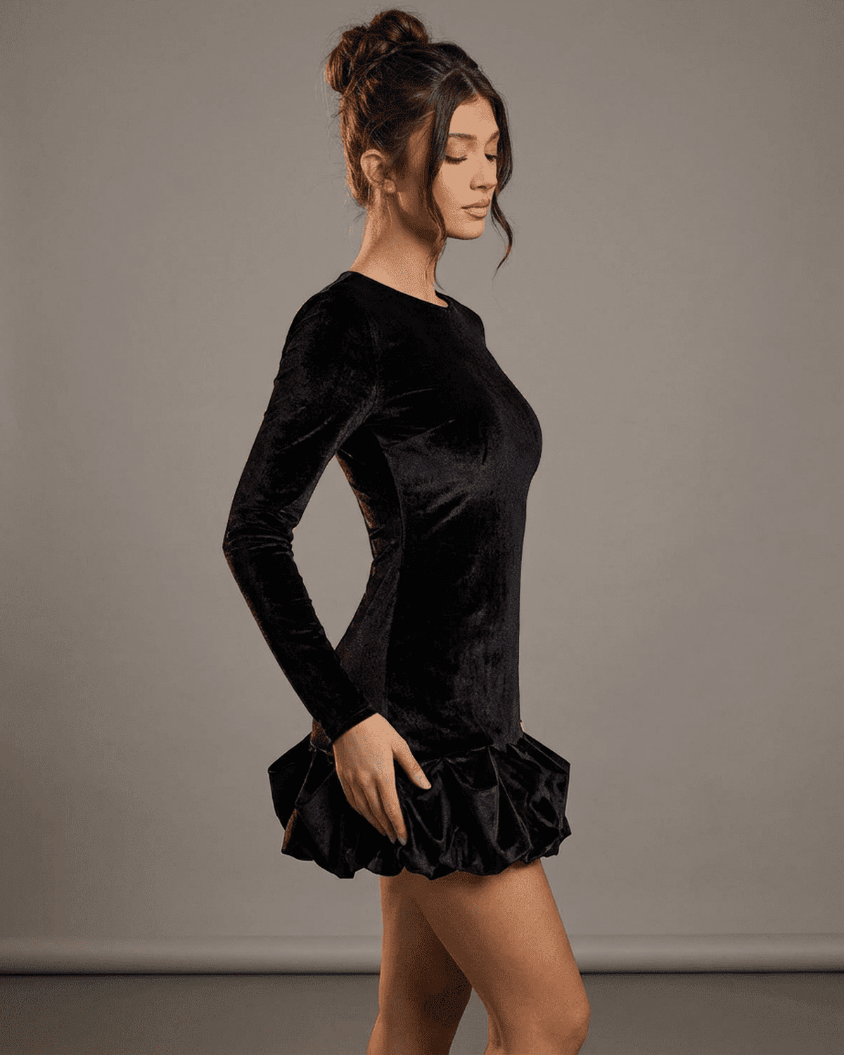 Velora Mini Dress Black by SLIMONA, showcasing luxe velvet fabric and pleated hem for a stylish bodycon silhouette.