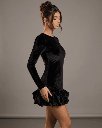 Velora Mini Dress Black by SLIMONA, showcasing luxe velvet fabric and pleated hem for a stylish bodycon silhouette.