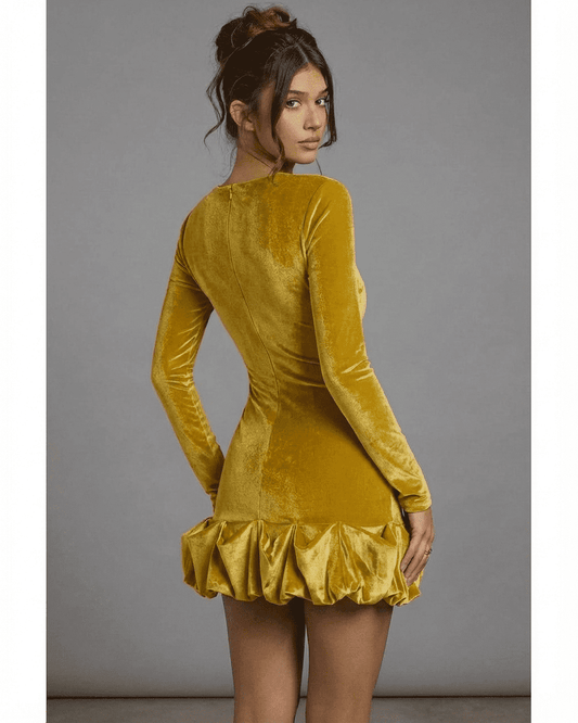 Velora Mini Yellow dress by SLIMONA showcasing luxurious velvet fabric and a pleated hem, perfect for evening wear.