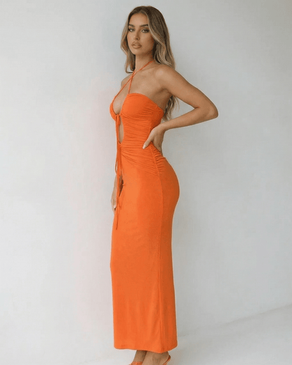 Solara Maxi Dress by Lauven featuring a halter neck and ruched detail, showcasing a sleek orange ankle-length silhouette.