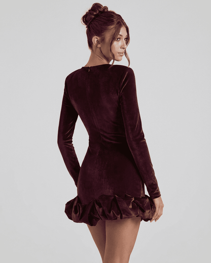 Velora Mini Dress by SLIMONA, showcasing the luxurious burgundy velvet and pleated hem from the back view.