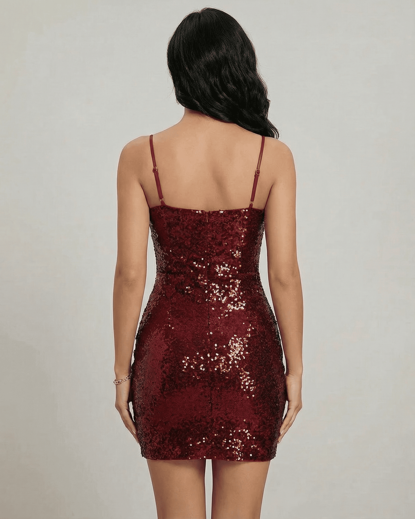 Rear view of the Verona Mini Dress by SLIMONA, showcasing its sparkling sequins and fitted silhouette.